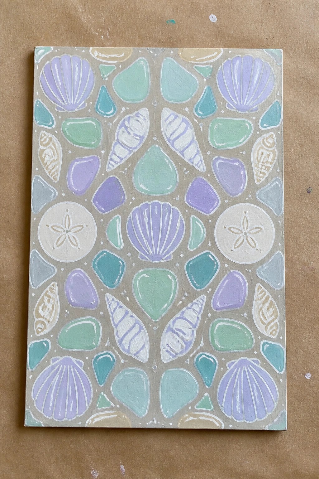 Colorful painting of seashells and pebbles in pastel purple, blue, and green.