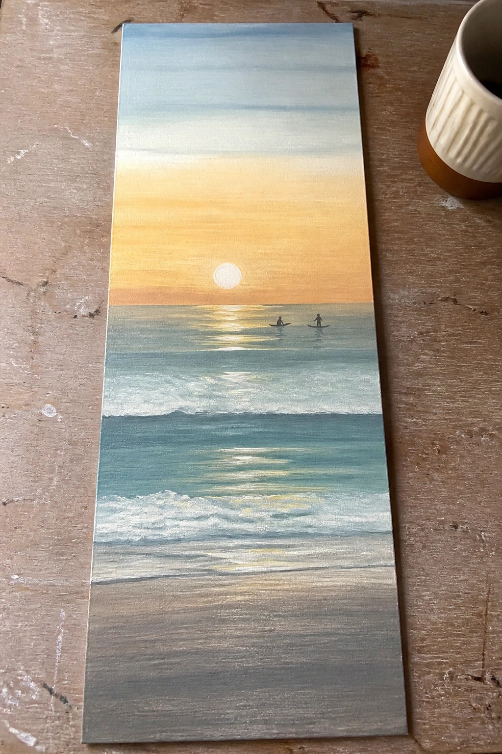 Sunset seascape painting with orange sky, white sun, teal waves, and two surfers
