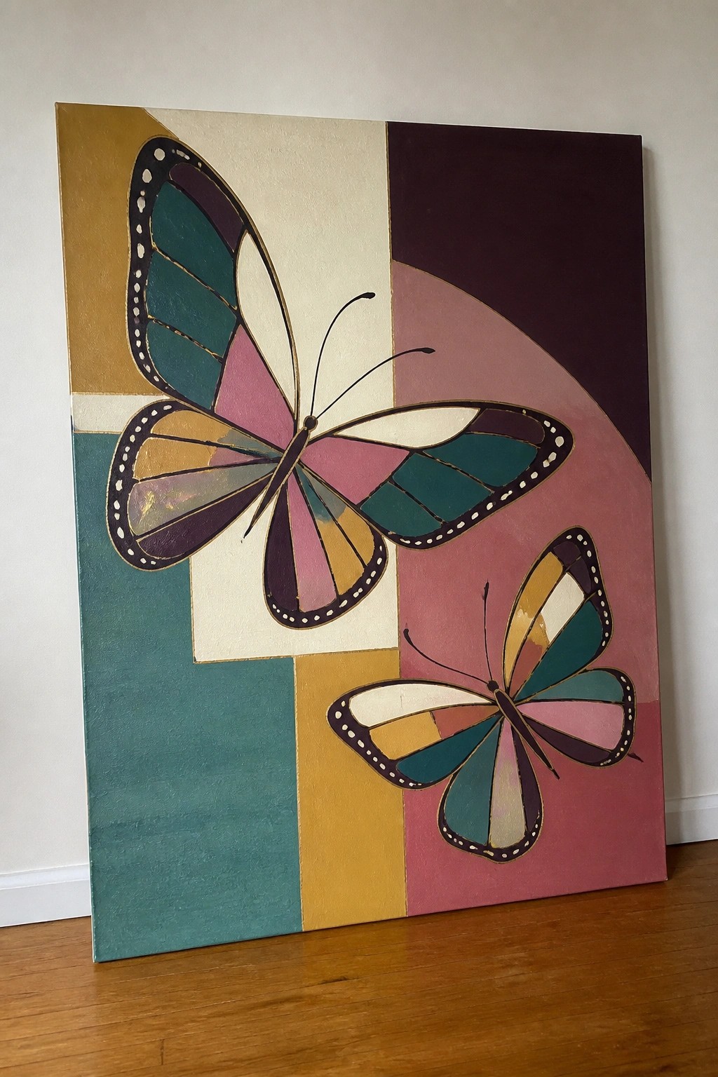 Abstract painting of two colorful butterflies on geometric blocks of gold, teal, pink, and purple.