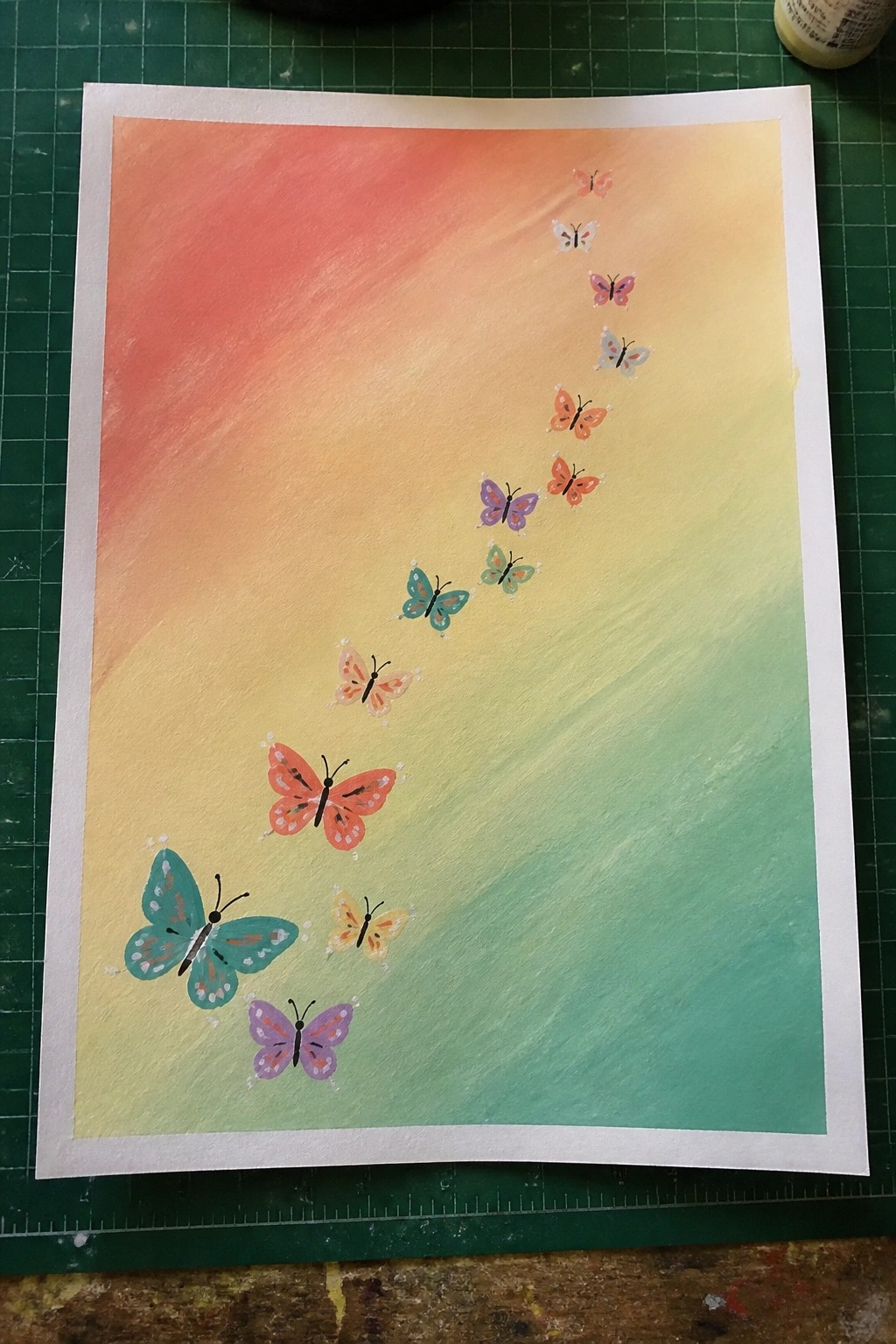 Colorful butterflies trail upward on a red-to-green watercolor gradient background
