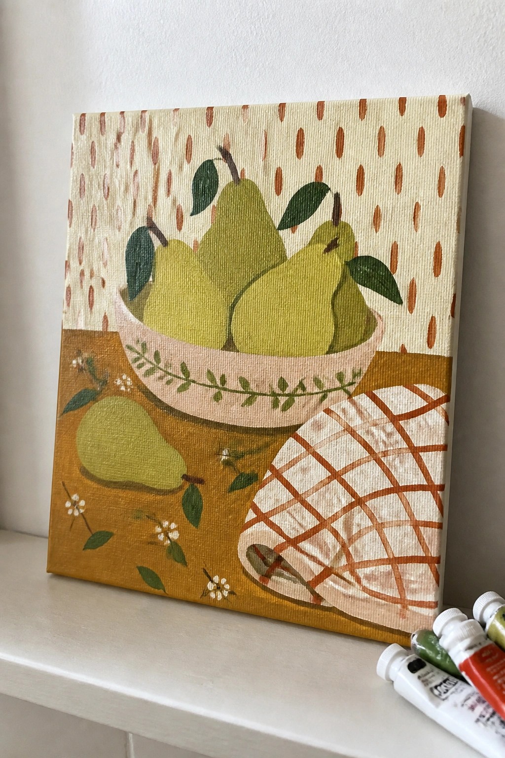 Colorful still life painting of green pears in bowl with checkered cloth
