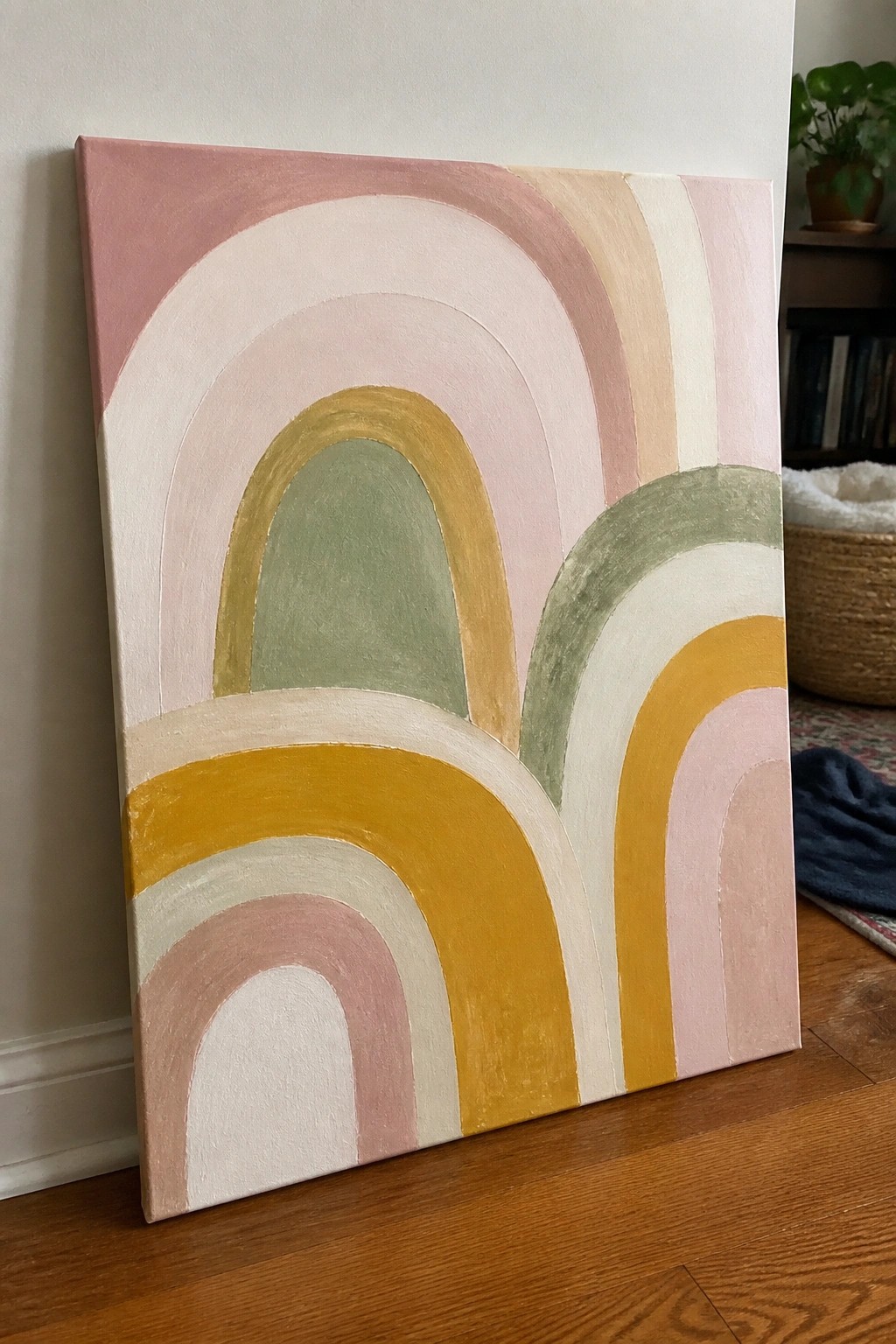 Abstract painting with overlapping pastel rainbow arches in pink, yellow, and green