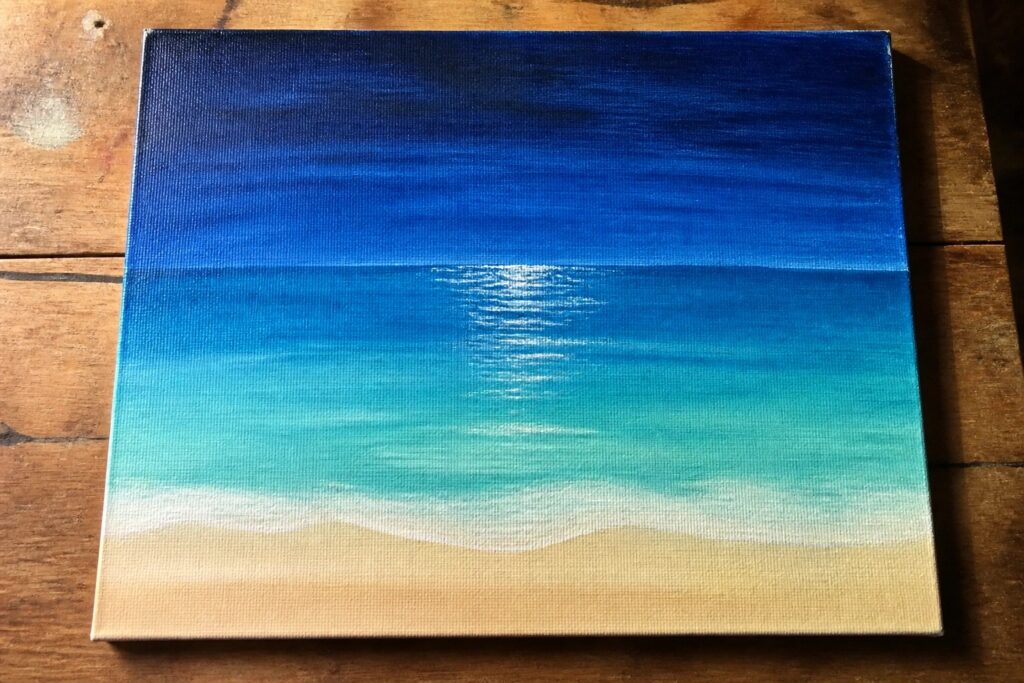 19 Stunning Summer Acrylic Seascape Painting Ideas Using Layered Ocean Blues Blue gradient seascape painting with white sun reflection, teal waves, and sandy beach on wood.