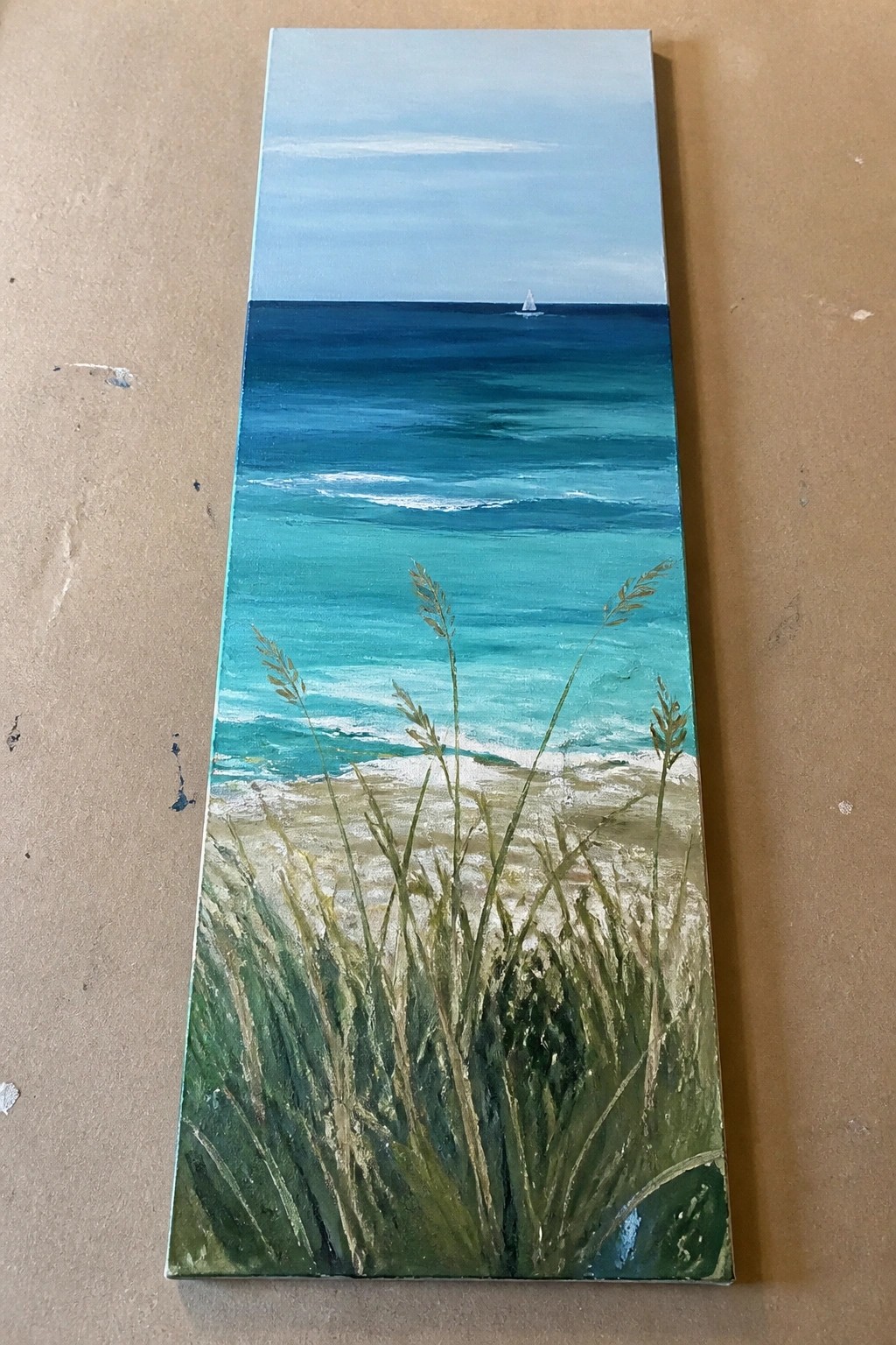 Vertical seascape painting with turquoise waves, distant sailboat, and tall foreground beach grass.