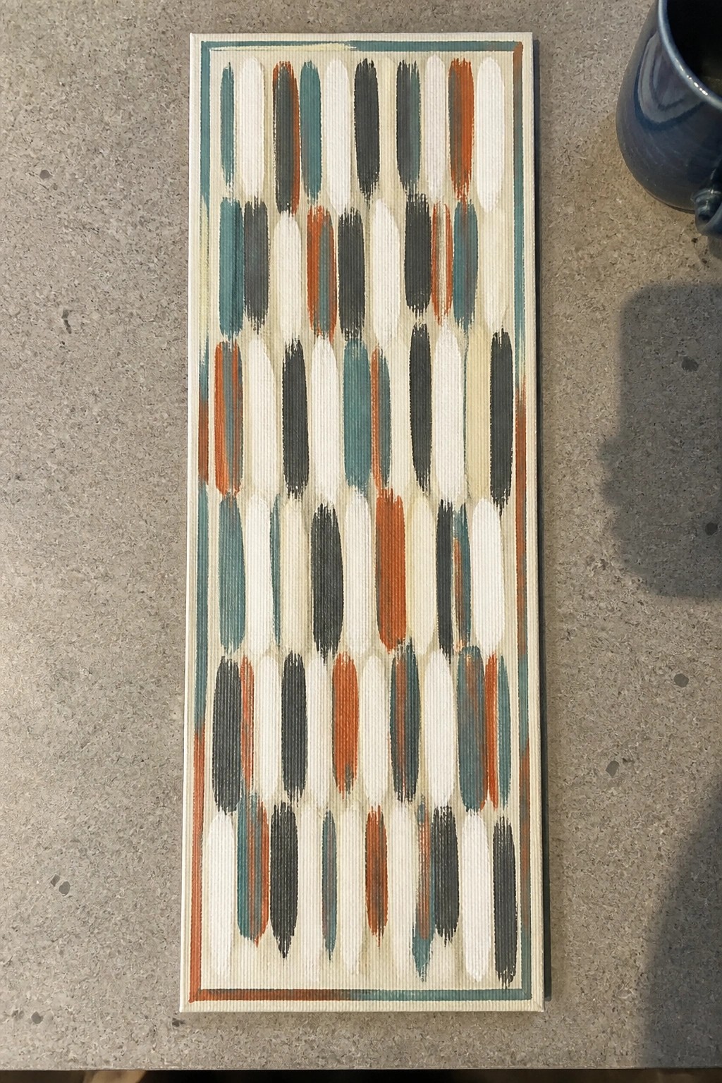 Rectangular acrylic painting with rows of vertical brushstrokes in teal, rust, dark gray, and white on a light background with a thin border.
