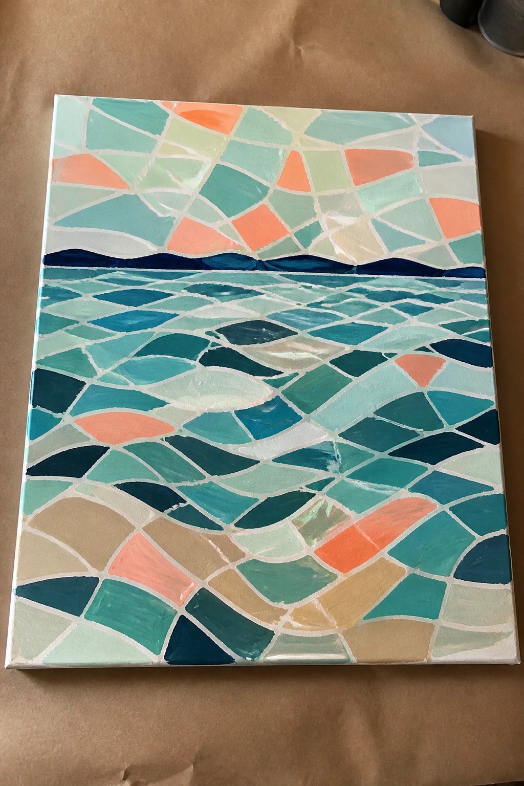 Colorful mosaic painting of sunset over dark hills and rippling ocean waves.