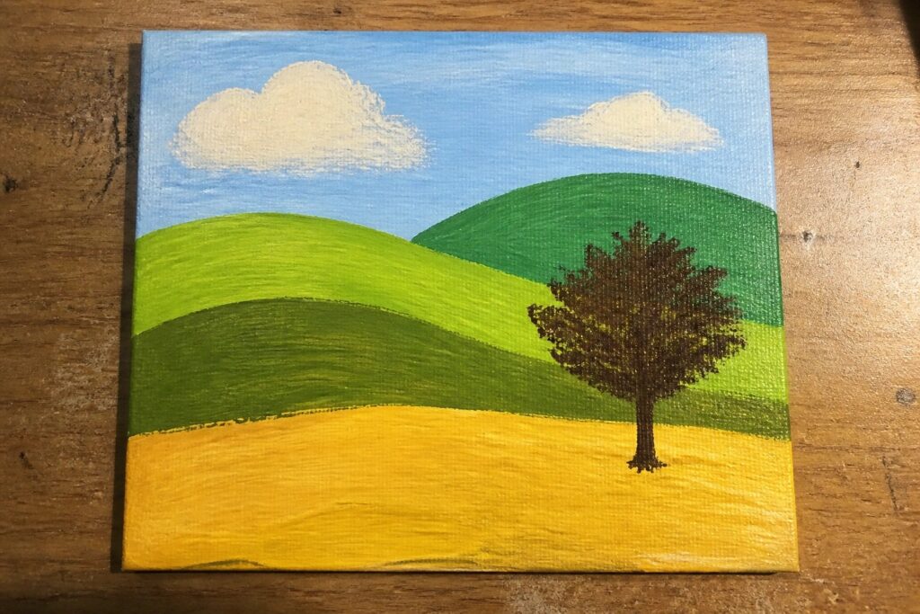 Landscape painting with green rolling hills, yellow field, lone tree, blue sky and clouds.