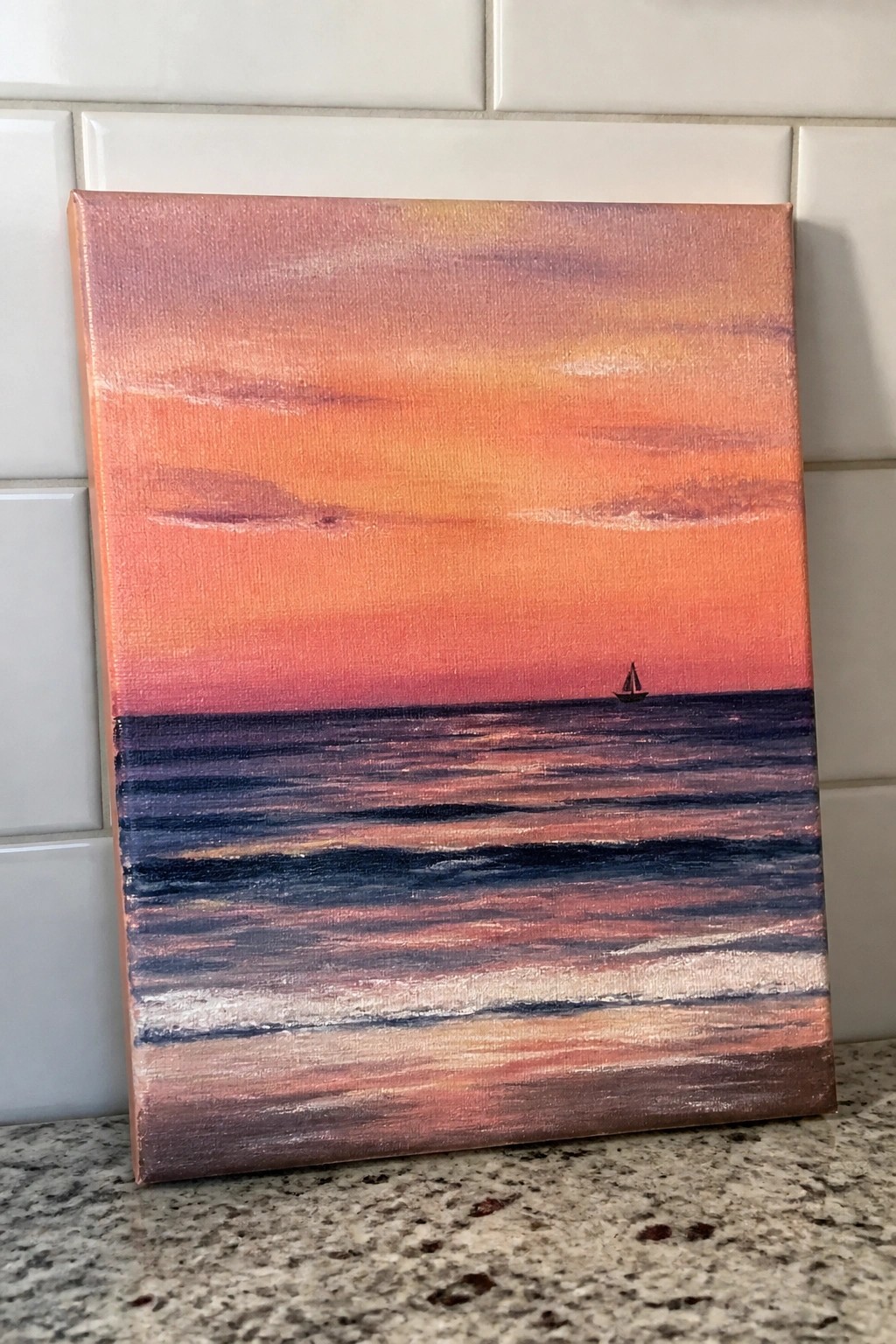 Painting of vibrant sunset over ocean waves with distant sailboat on canvas.