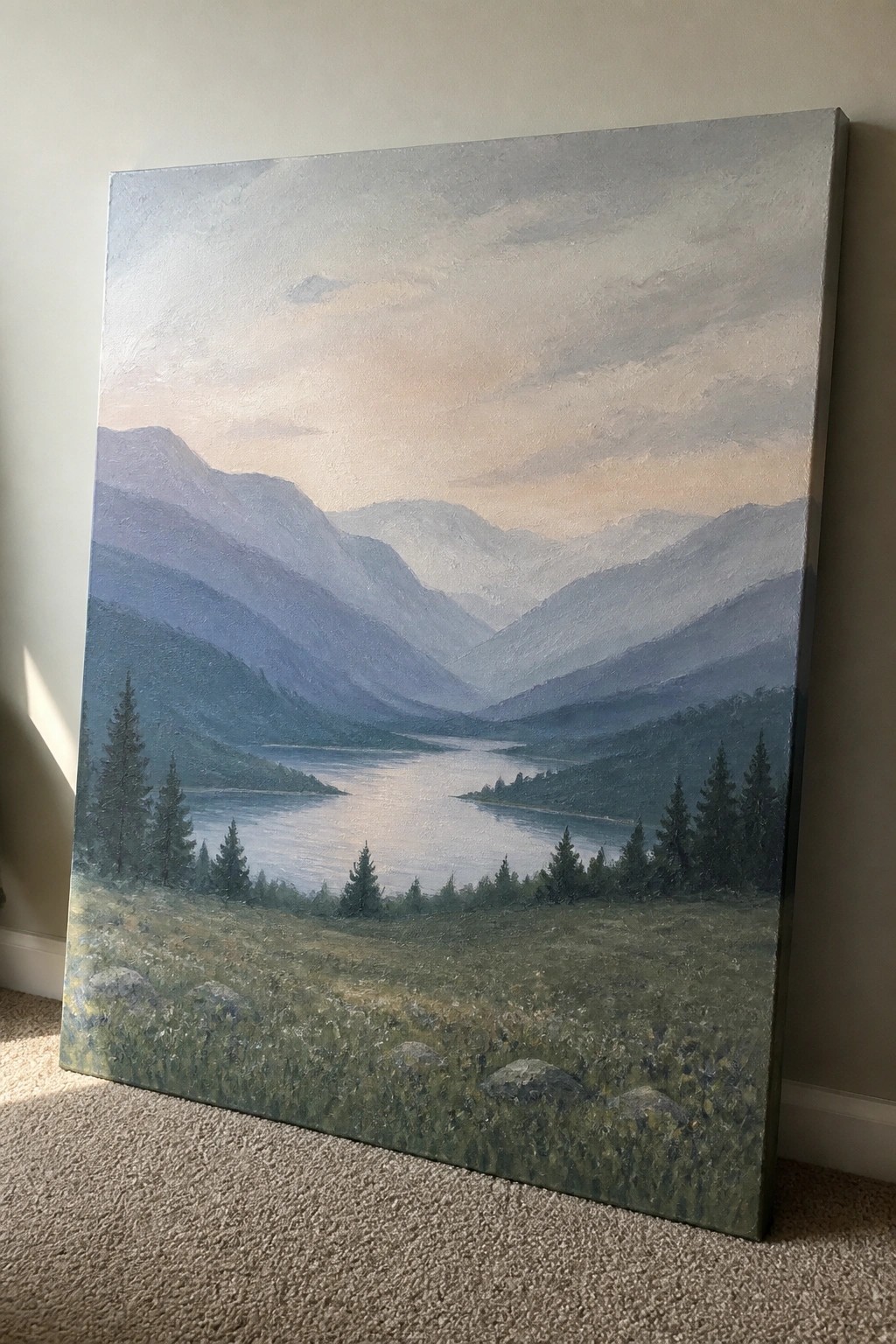 Large canvas painting of misty mountain lake amid green forests leaning on carpet