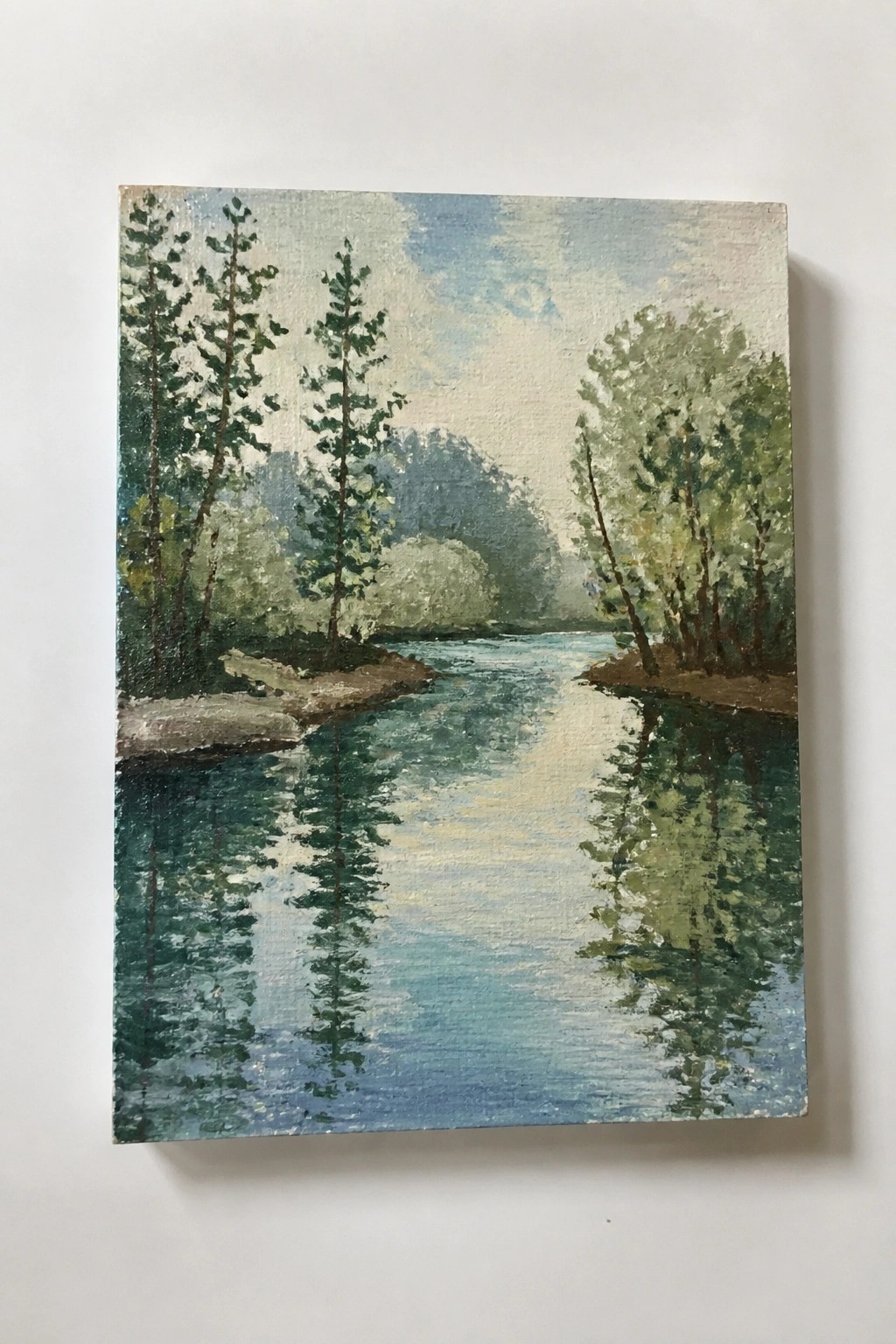 Impressionistic painting of a calm blue river reflecting trees under a cloudy sky