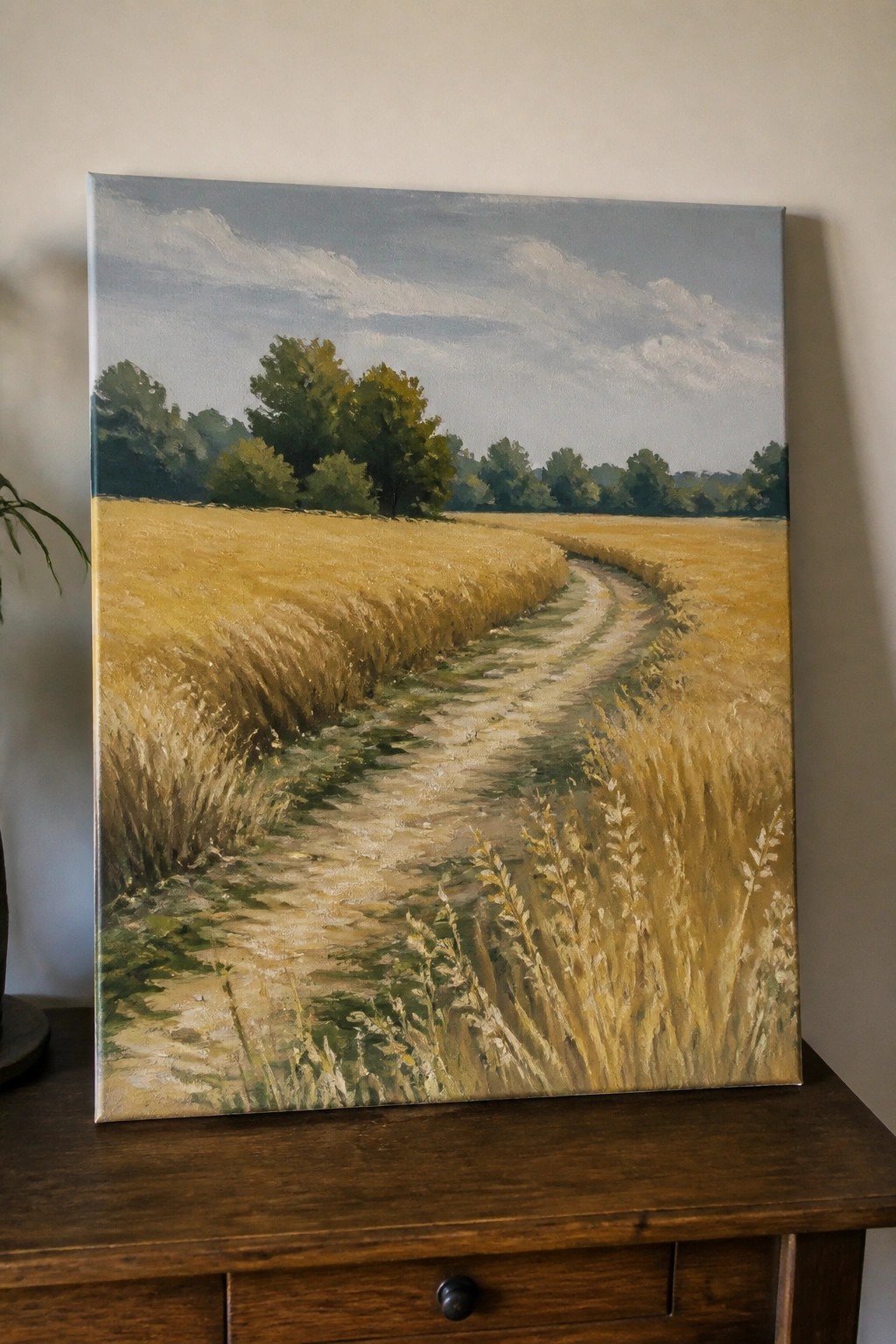Realistic oil painting of winding dirt path through golden wheat field with trees.