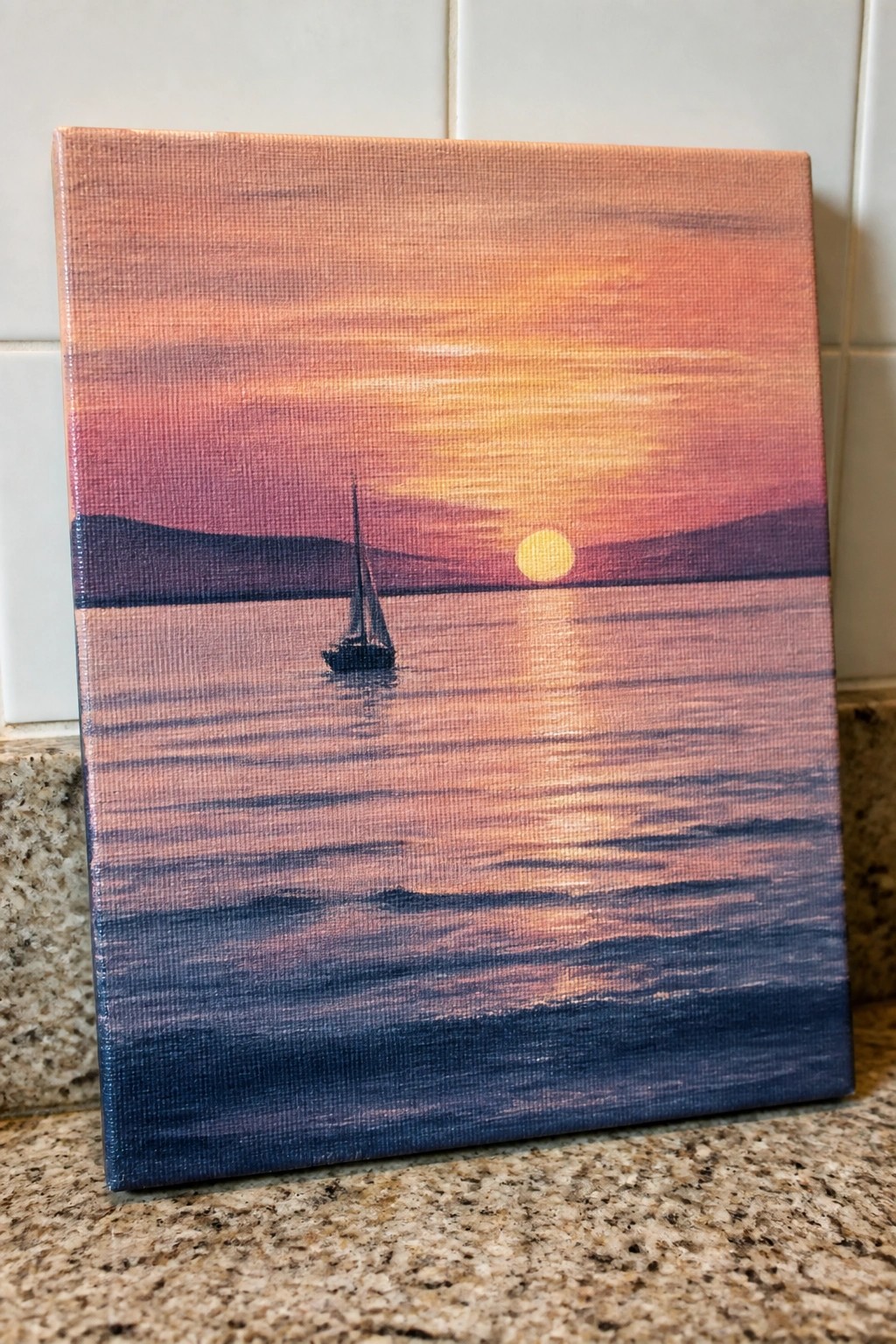 Canvas painting of sailboat on calm water under vibrant orange-pink sunset.