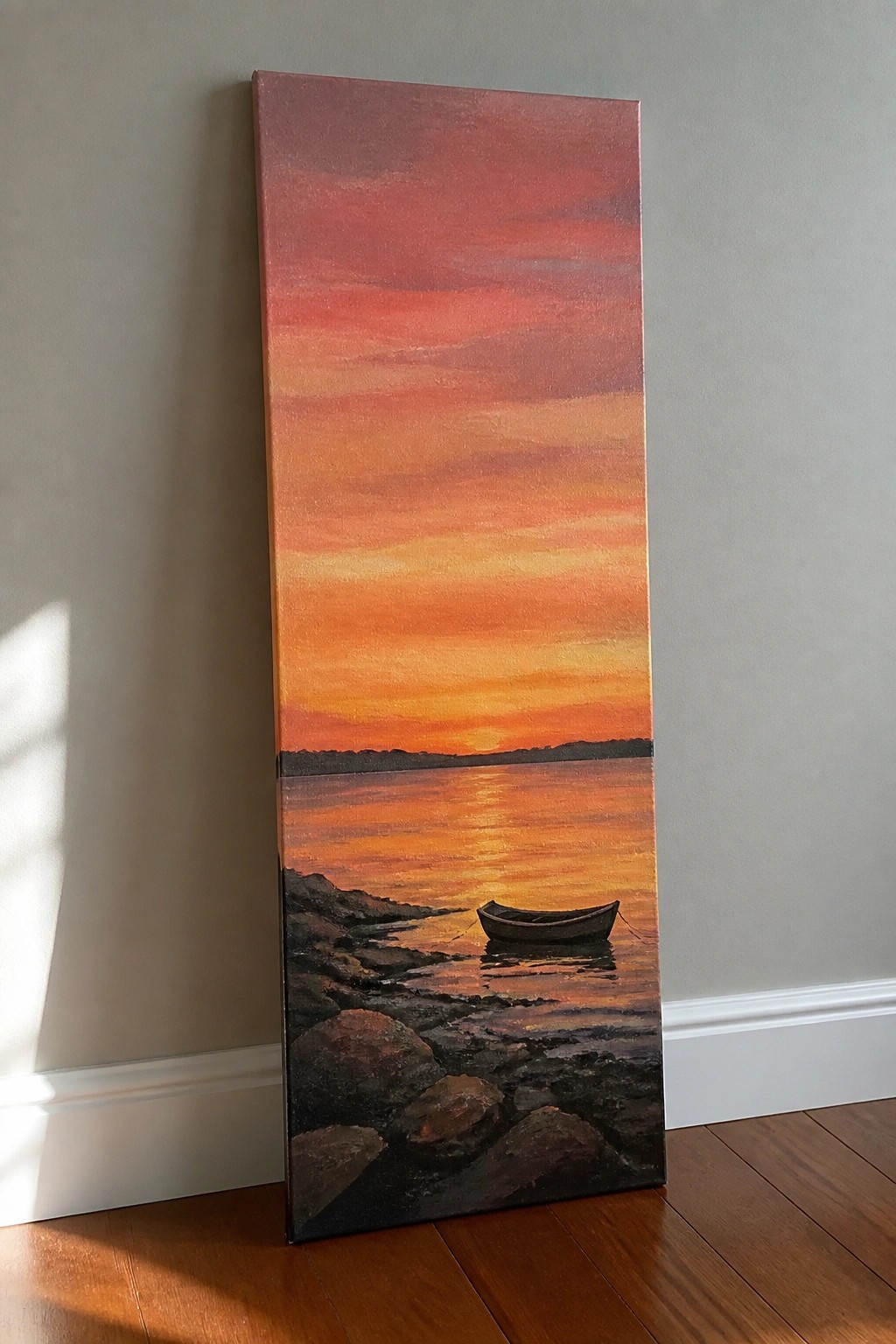Tall vertical painting of vibrant sunset with small boat on rocky shore against wall