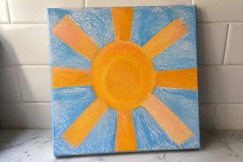 Vibrant canvas painting of yellow sun with orange rays on blue sky background