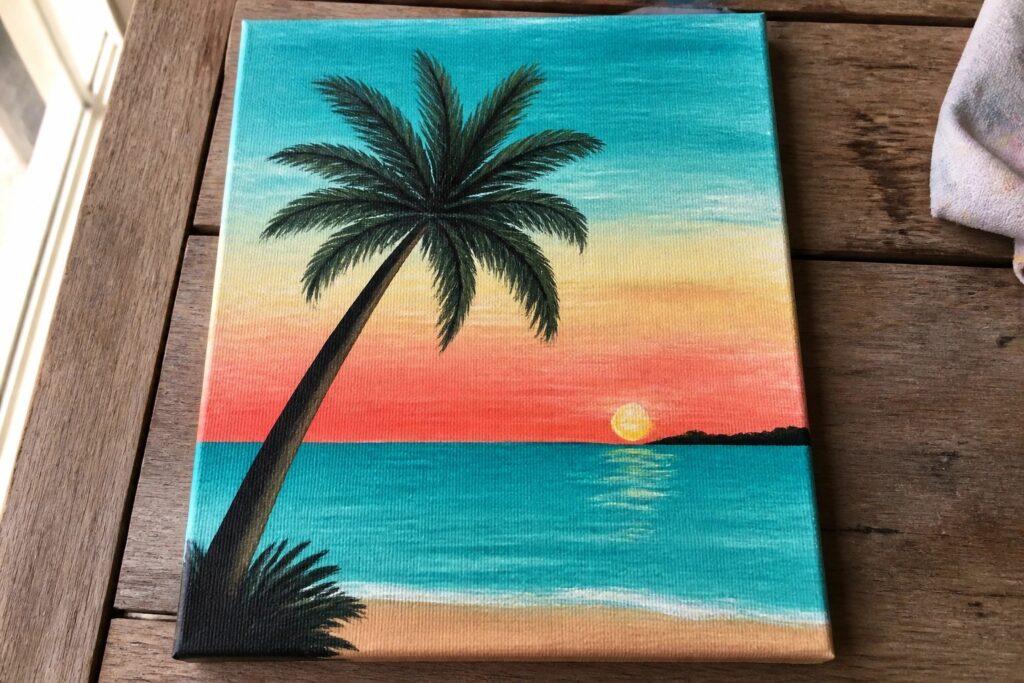 Canvas painting of palm tree over ocean at vibrant sunset with reflection
