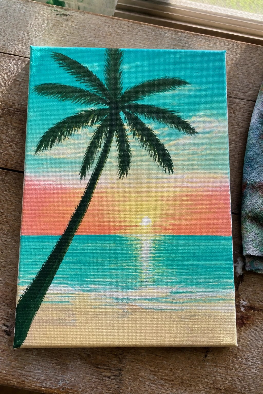 Canvas painting of palm tree over ocean at vibrant sunset with reflection