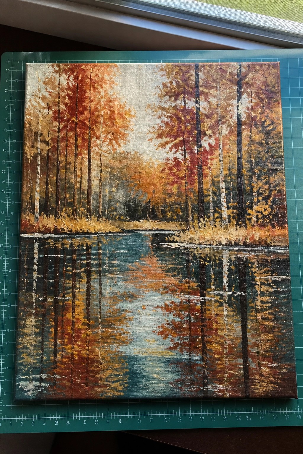 Vibrant autumn forest painting with colorful trees reflected in calm water
