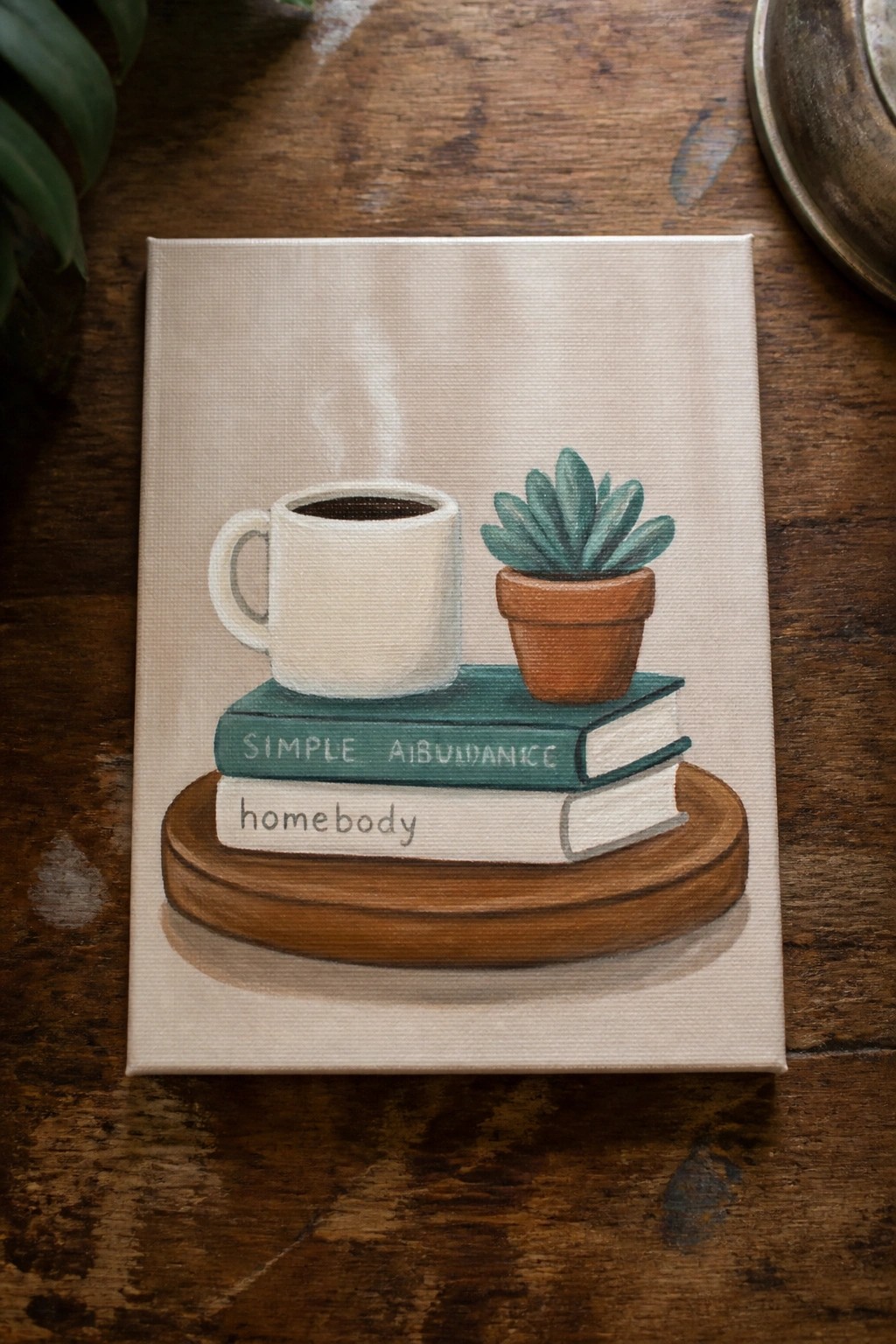 Canvas painting of steaming white mug, succulent, and books on wooden tray