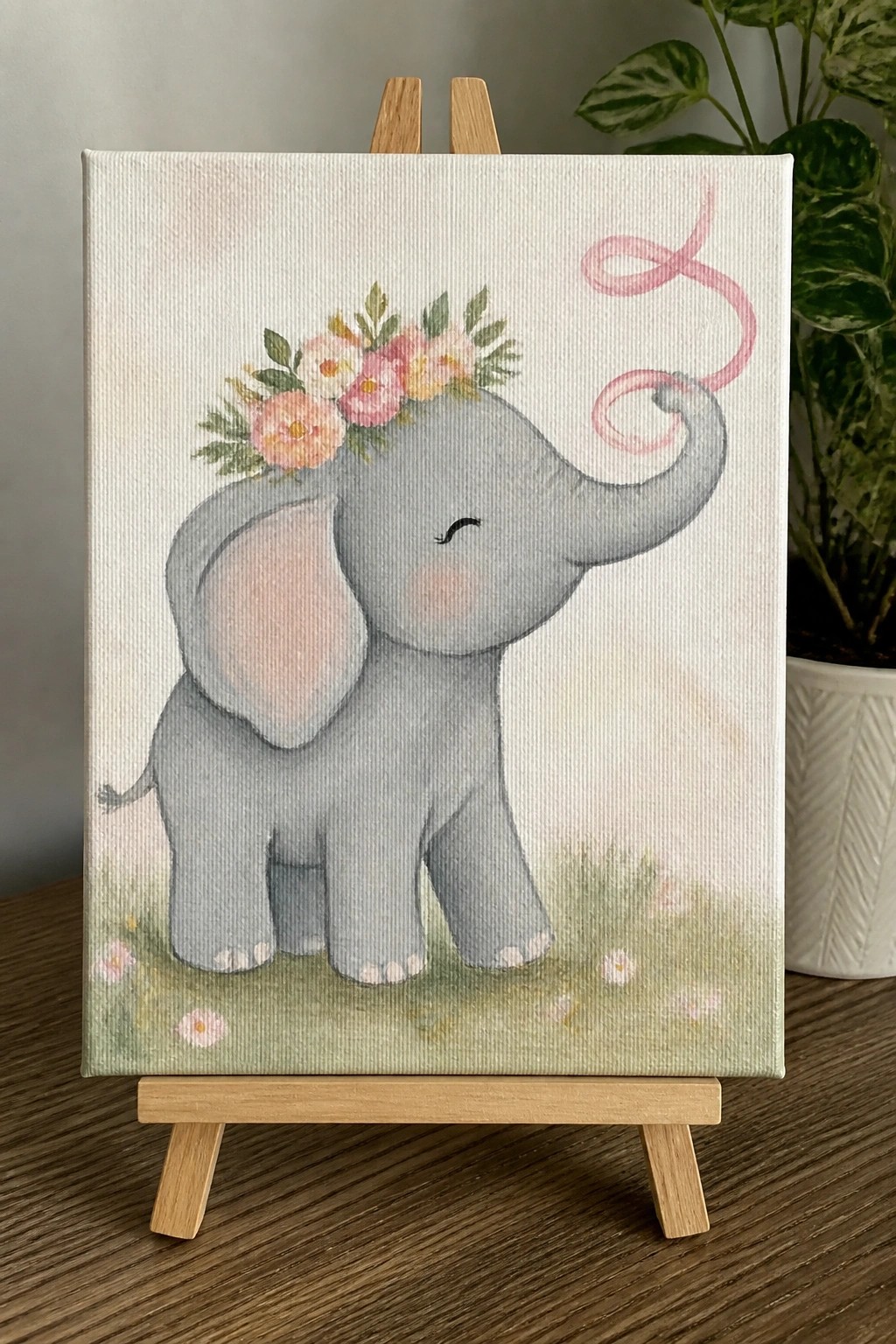Baby elephant painting with floral crown and pink ribbon on wooden easel