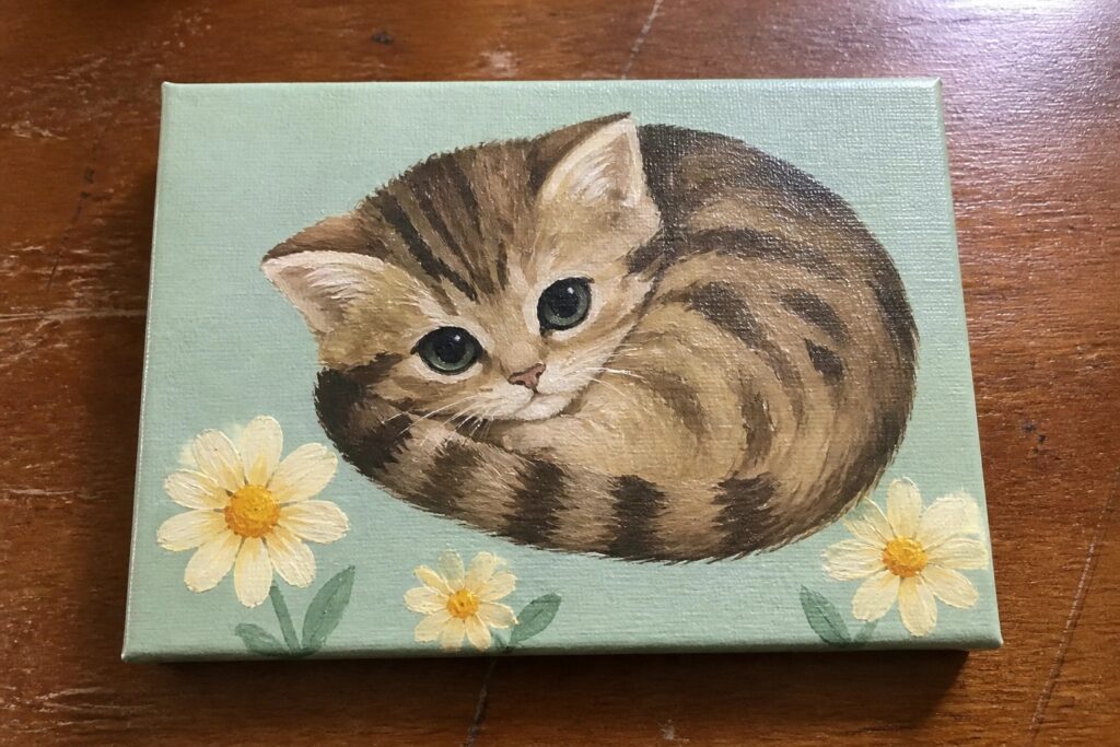 23 Cute Animal Acrylic Paintings That Are Beginner-Friendly and Fun Curled tabby kitten with green eyes beside two daisies on light green canvas.
