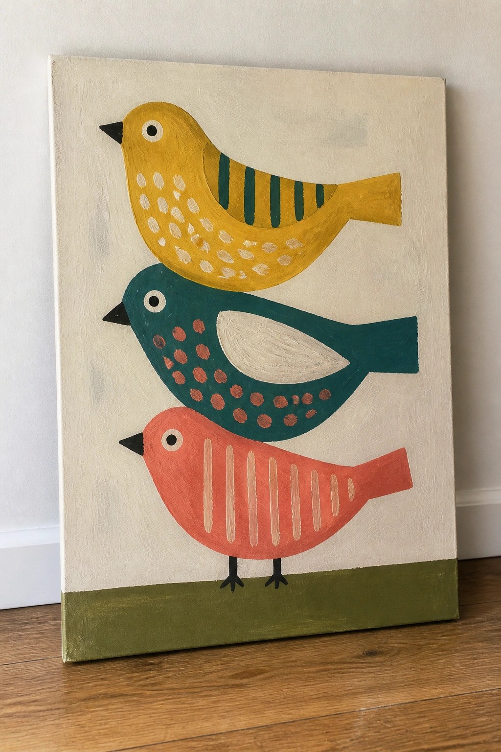 Three stacked abstract birds in yellow, teal, and red on canvas.