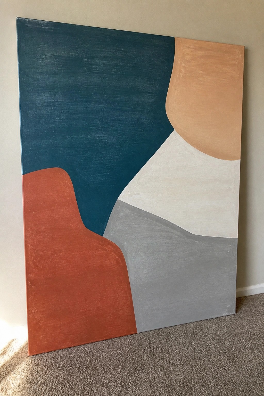 Abstract painting with curved teal, orange, white, gray, and peach shapes against wall