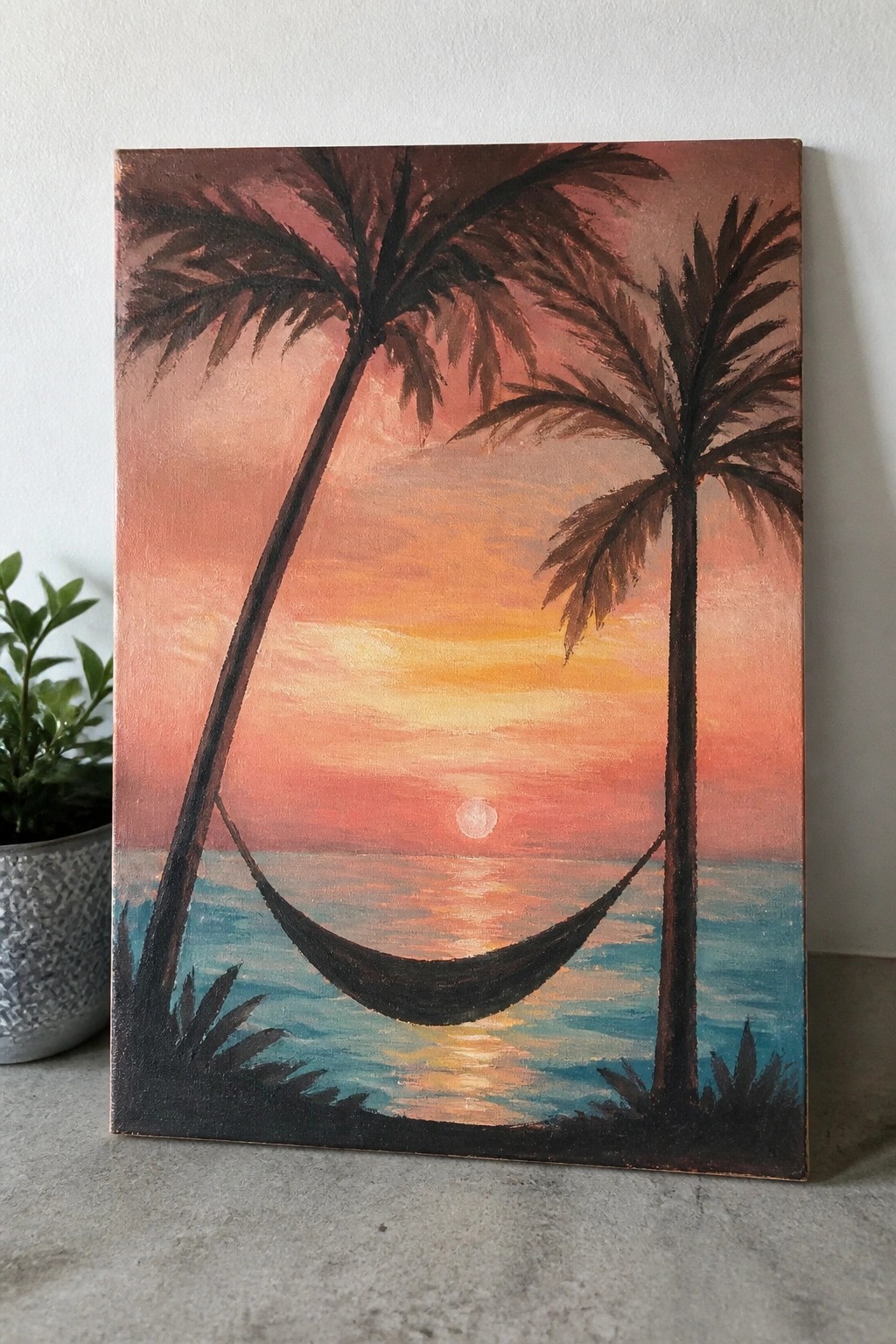Canvas painting of palm trees with hammock overlooking vibrant ocean sunset.