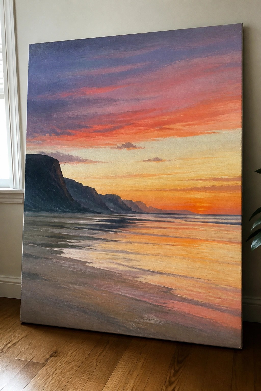 Large painting of vibrant sunset over ocean with dark cliffs and colorful sky.