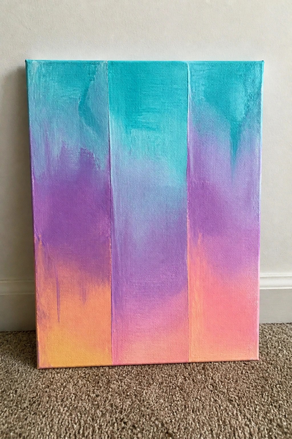Abstract canvas painting with vertical gradient blending teal, purple, and orange hues.