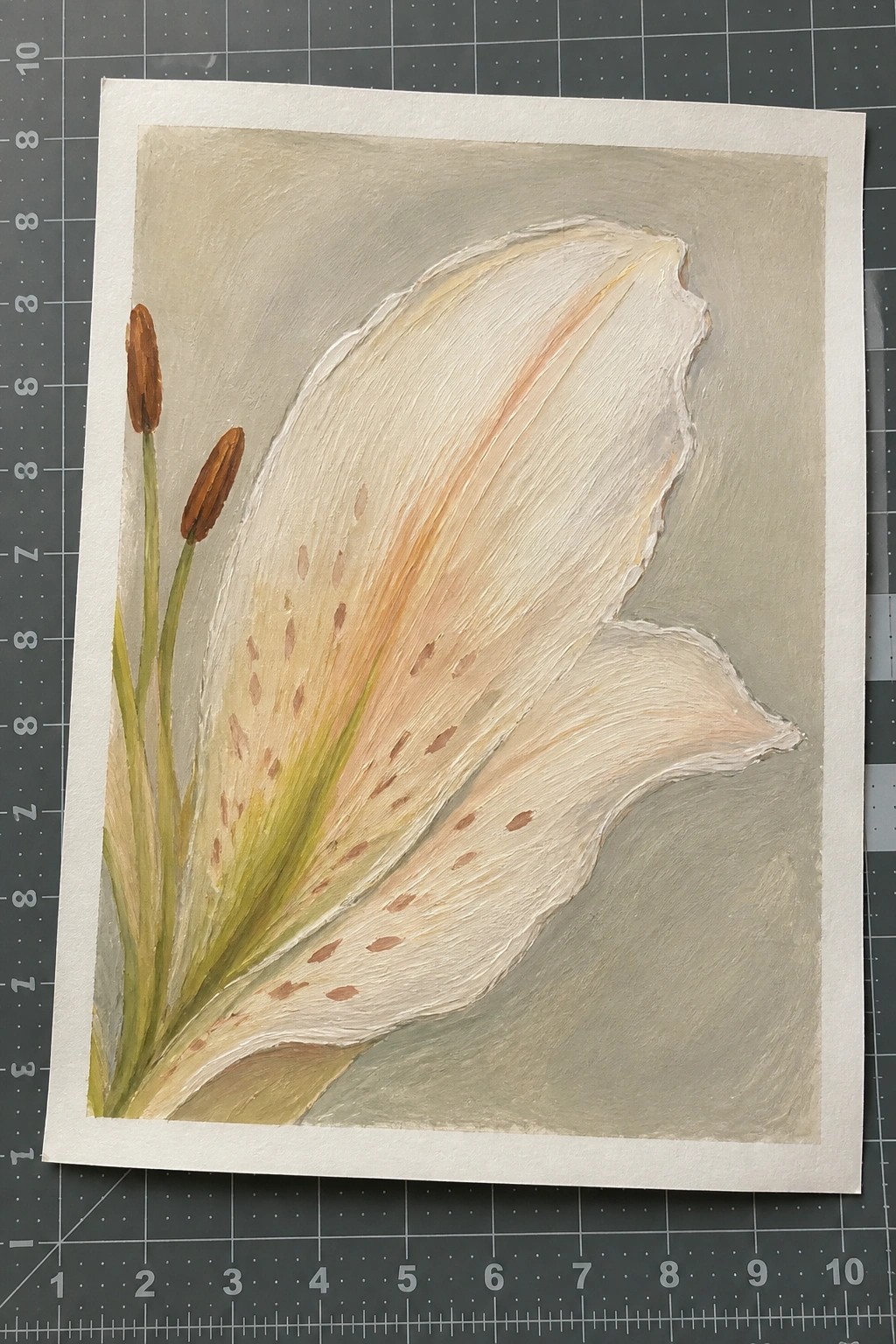 Watercolor painting of white lily with brown-spotted petals and two closed buds on mat.