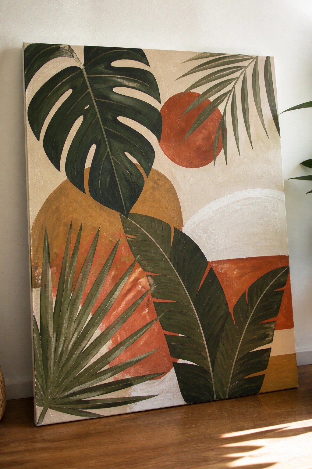 Abstract painting with green tropical leaves, terracotta shapes, and orange circle on canvas