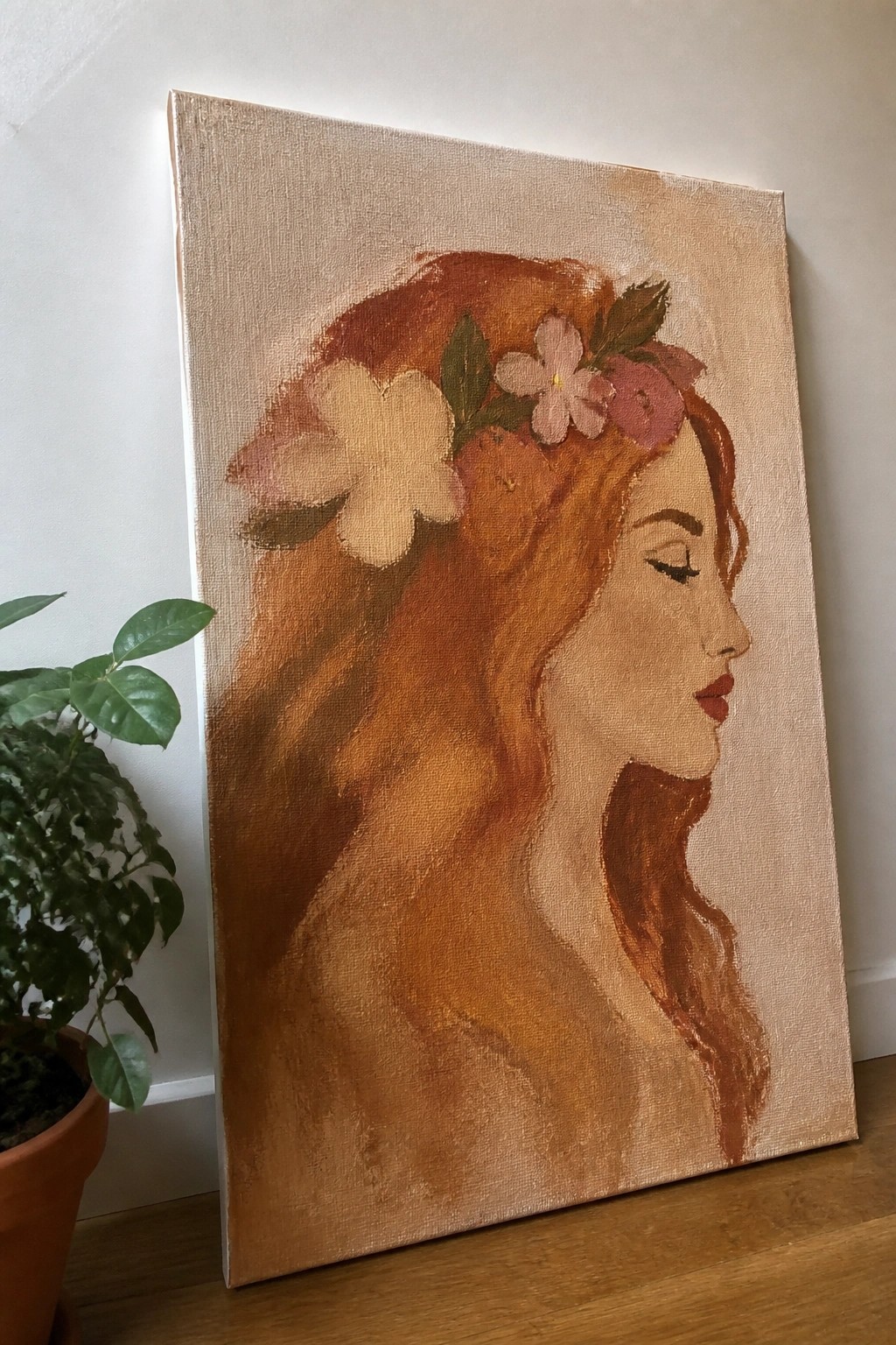 Painting of woman with long auburn hair and flowers in profile on canvas by plant