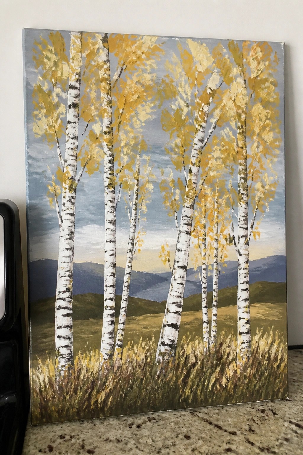 Painting of white birch trees with yellow leaves amid rolling hills and blue mountains.