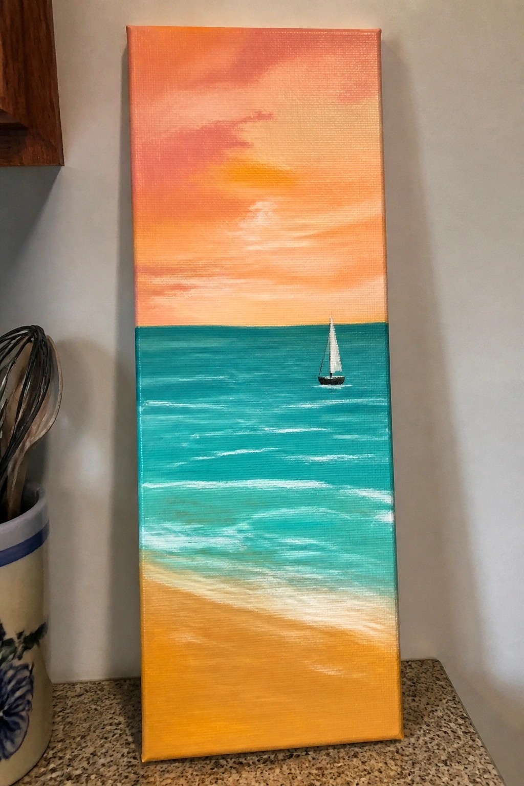 Vertical painting of orange sunset sky over turquoise ocean with sailboat and sandy beach.