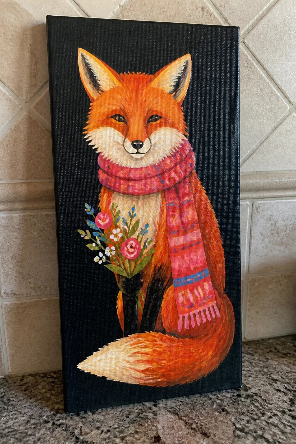 Orange fox in pink scarf holds flower bouquet on black canvas.
