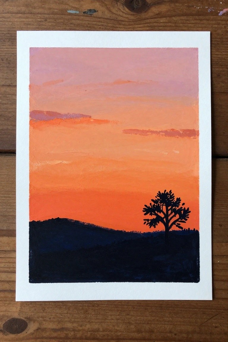 Vibrant orange-pink sunset sky over dark hills with silhouetted tree.