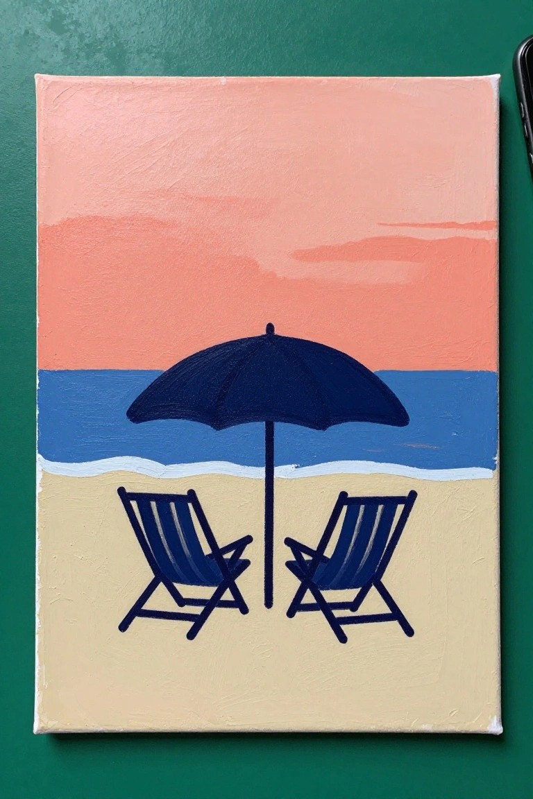 Two blue beach chairs and dark umbrella on sand by ocean under pink sunset sky.