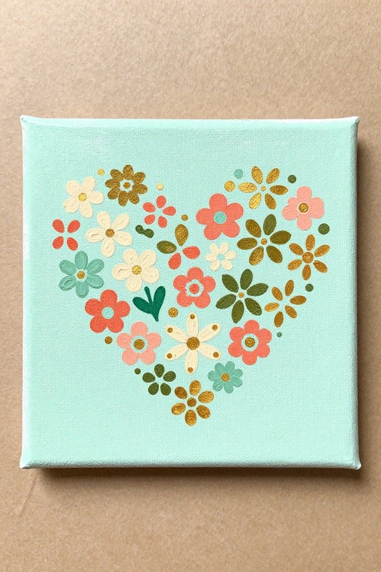 Mint green square canvas with heart-shaped floral painting in pink, coral, and gold