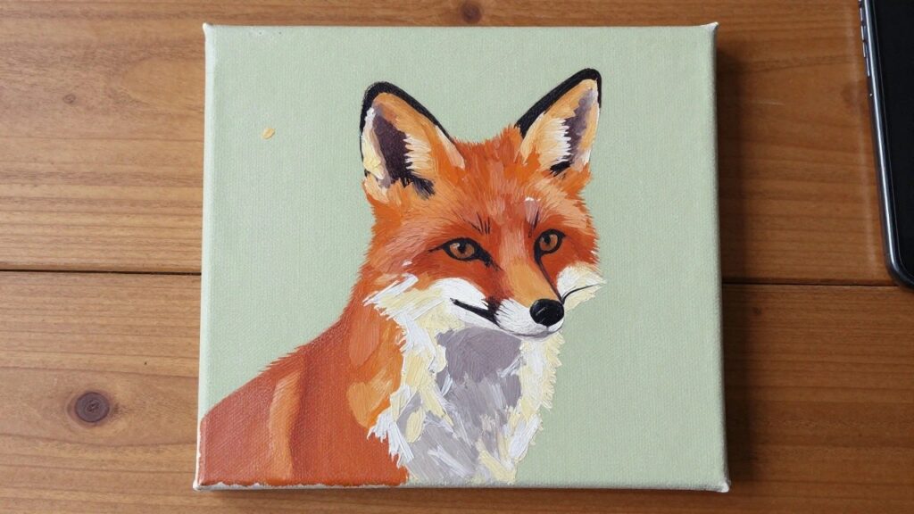 Thickly textured oil painting of orange fox on canvas atop wooden easel with paint below
