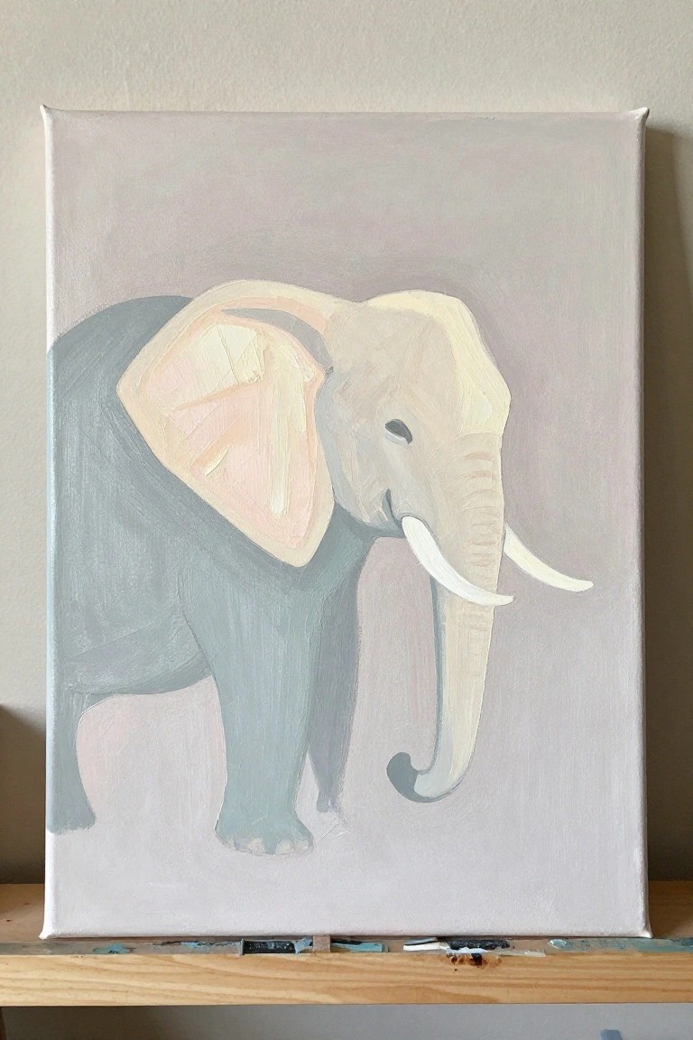 Gray elephant painting with white tusks and pink ear on canvas over wood