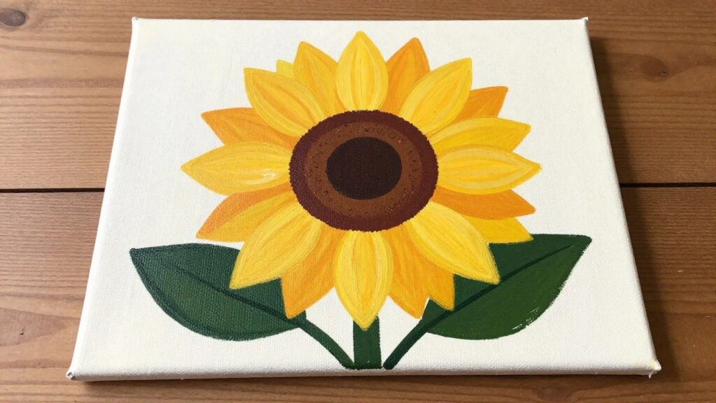 24 Modern Floral Acrylic Painting Ideas Featuring Oversized Graphic Blooms Yellow sunflower with brown center and green leaves painted on white canvas
