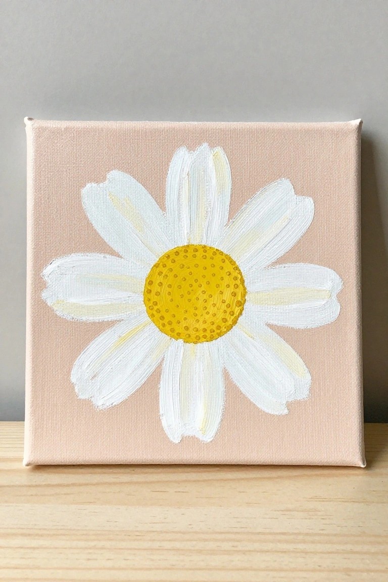 White daisy with yellow center painted on light pink square canvas on wood
