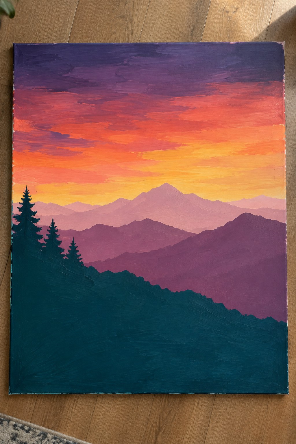 Vibrant sunset painting with layered purple mountains and silhouetted pine trees.