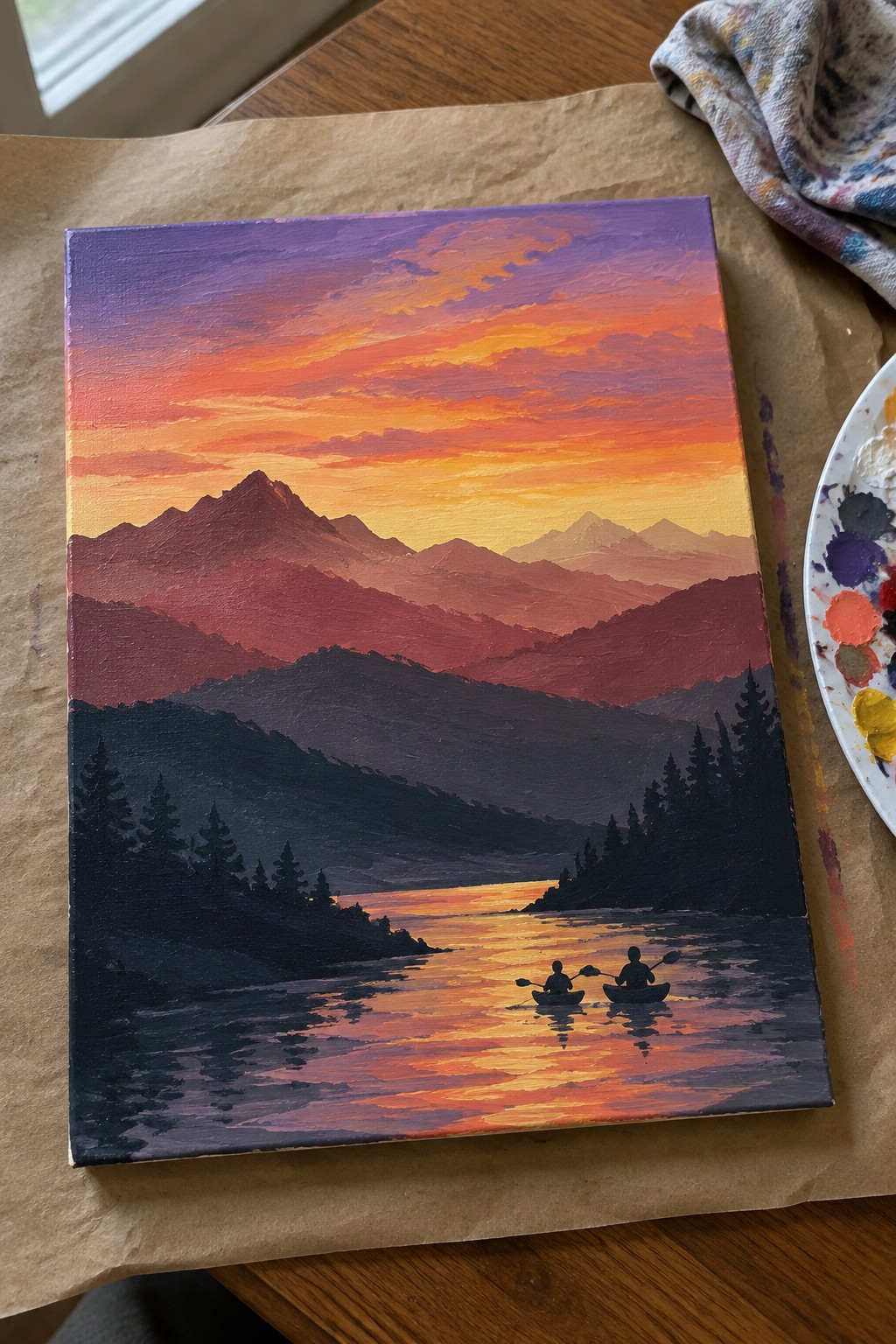 Vibrant oil painting of purple-orange sunset, layered mountains, and two kayakers on glowing lake