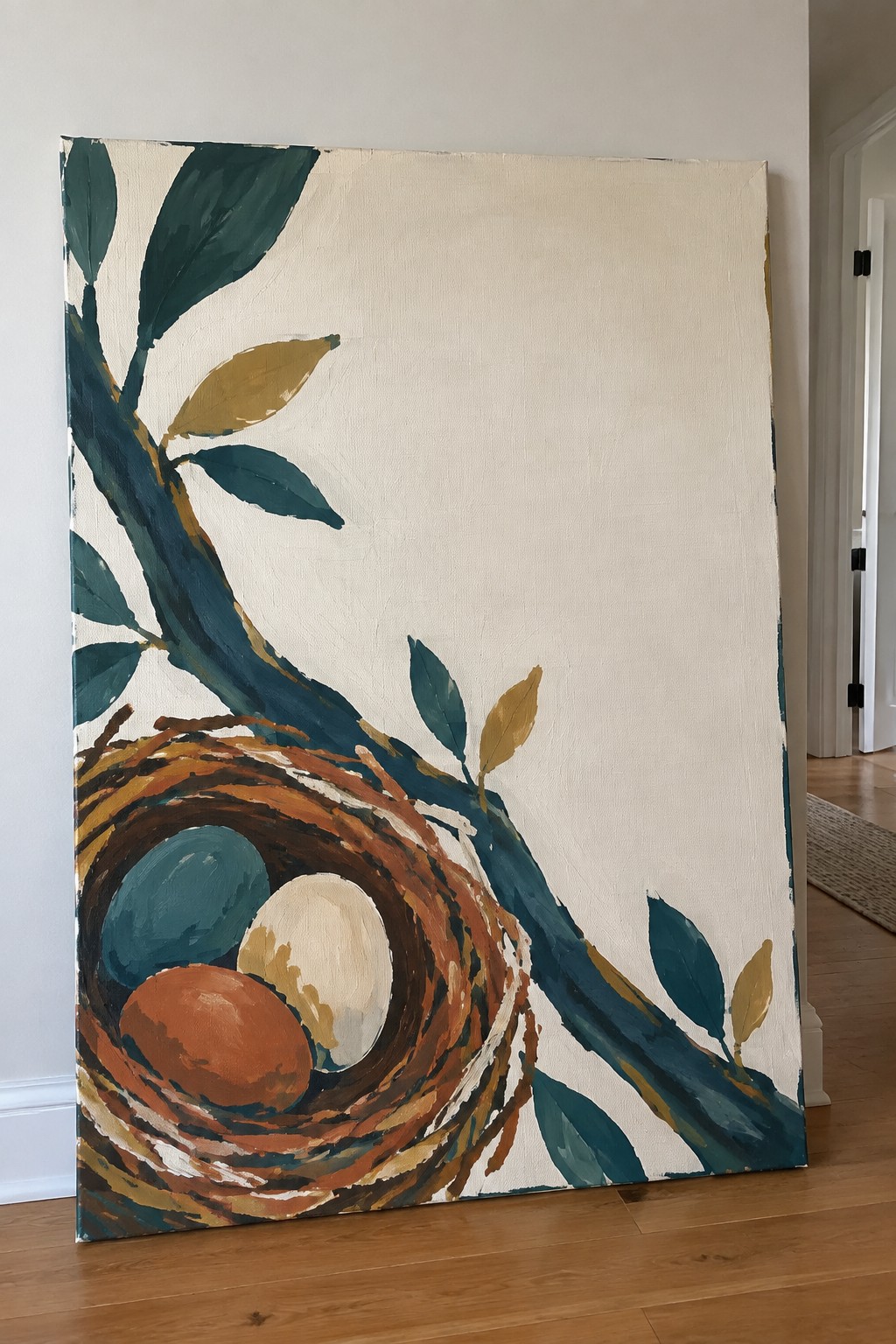 Abstract painting of bird nest with three eggs on leafy branch indoors