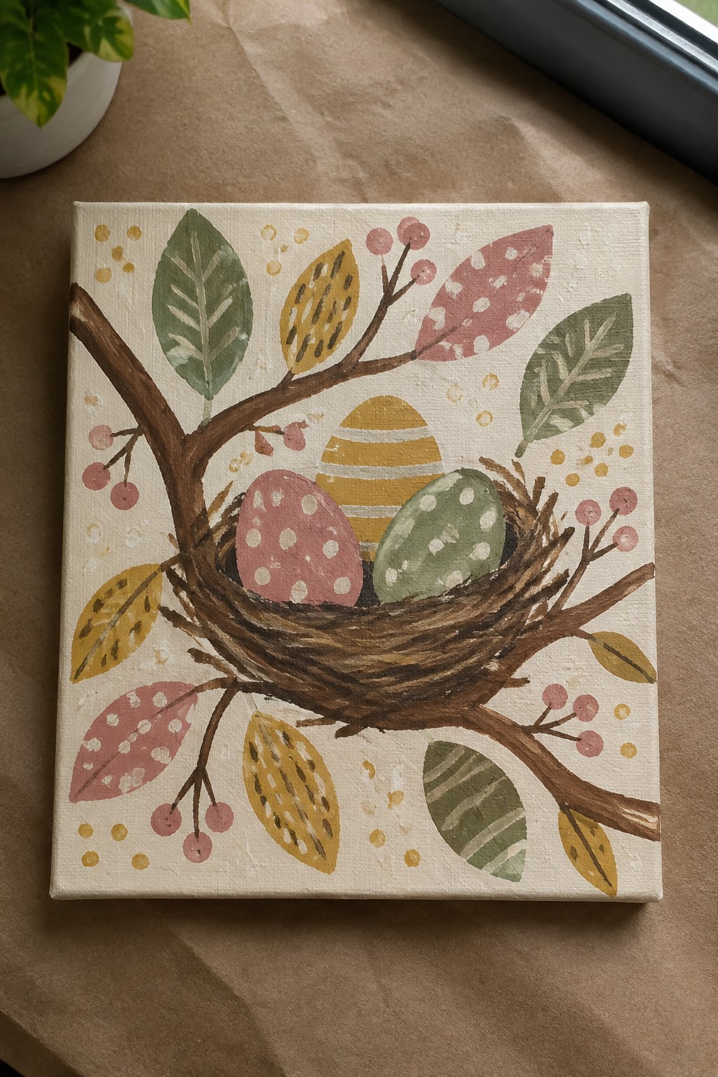 Pastel painting of nest with pink polka-dot, green dotted, and striped eggs among leaves and berries.
