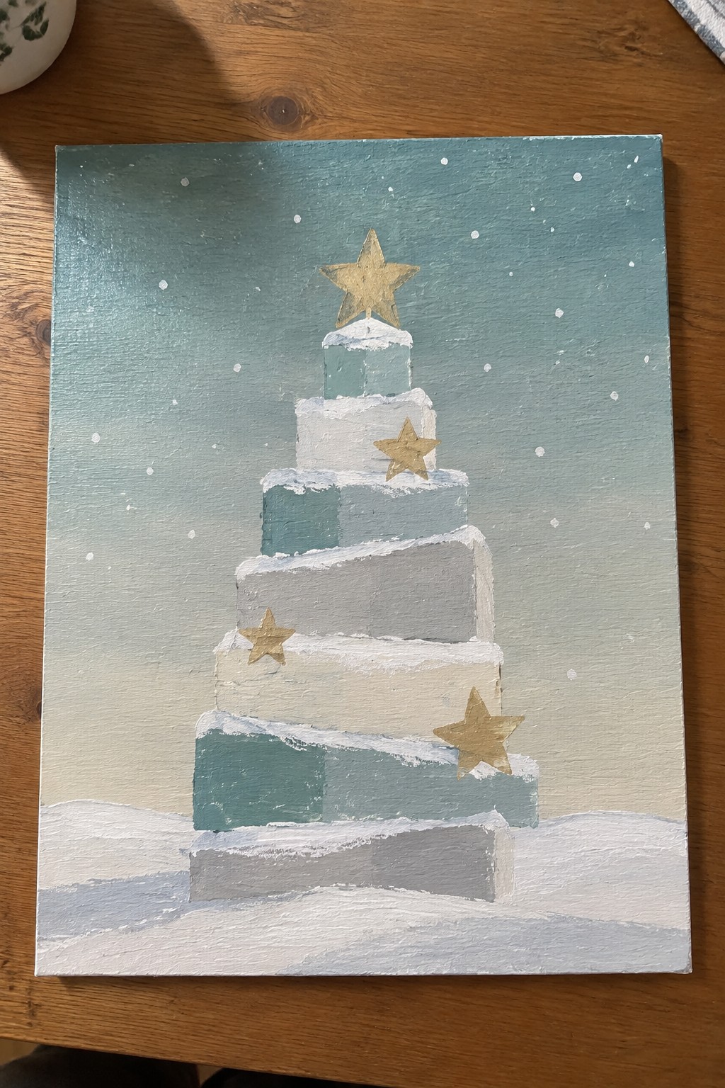 Tiered snow-covered Christmas tree painting in teal white gray with gold stars