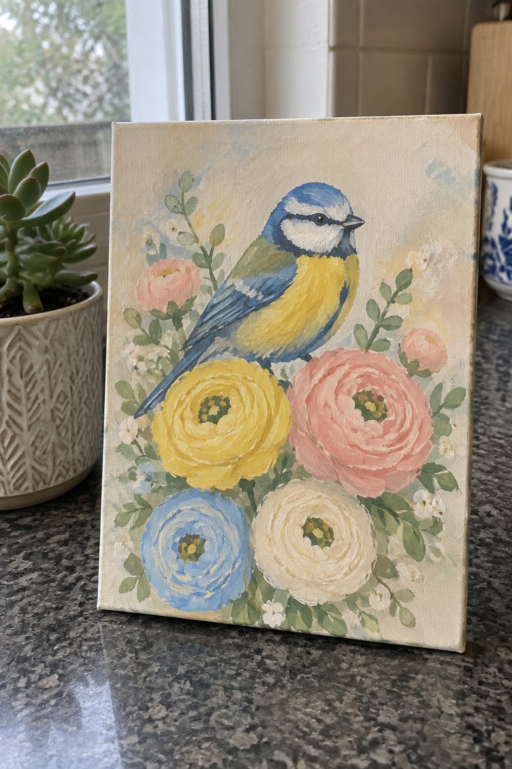 Canvas painting of blue-and-yellow bird amid pink, yellow, and blue flowers