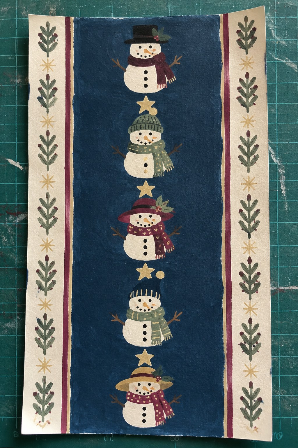 Five stacked snowmen in colorful hats and scarves with gold stars on navy blue.