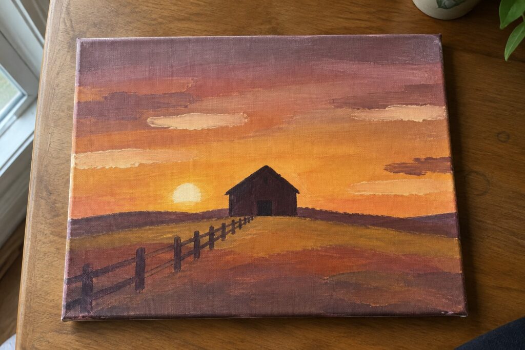 Painting of barn at sunset with wooden fence across golden field under orange sky
